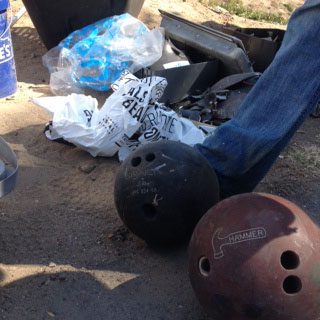 We found bowling balls! One of ILACSD's staff managed to shot put these guys into the dumpster