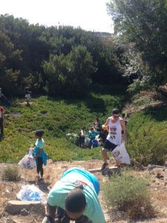 Volunteers cleaning a creek bed near Gompers Park