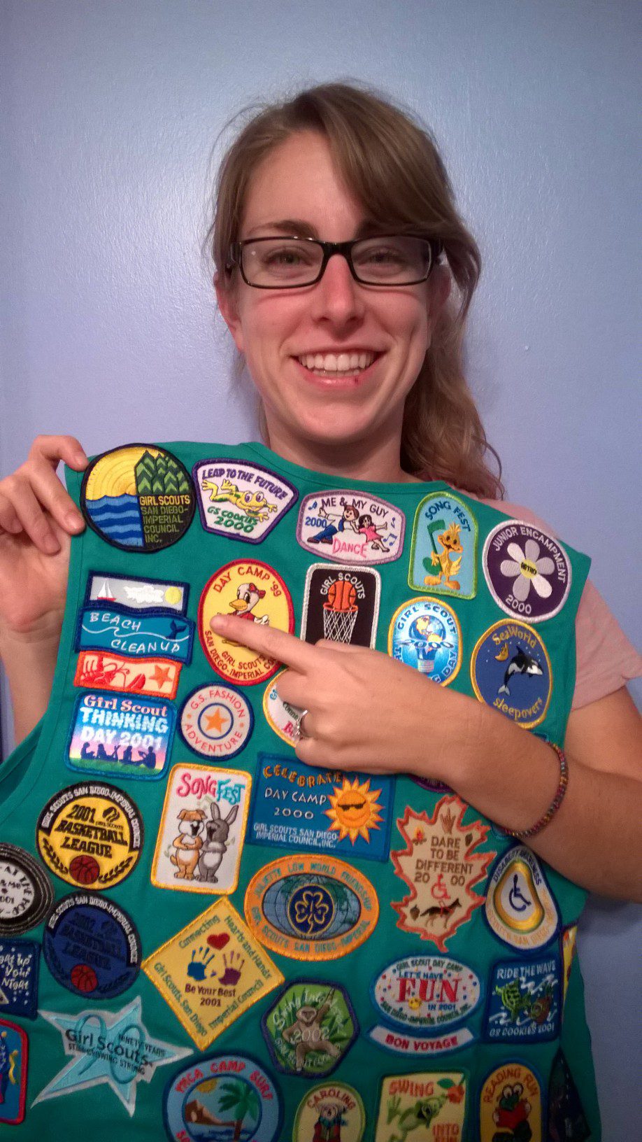 Emily poses proudly with her Girls Scout patch she received from ILACSD!
